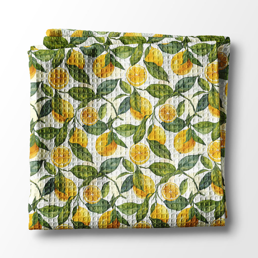 kitchen towel with lemon and leaf pattern on a white background