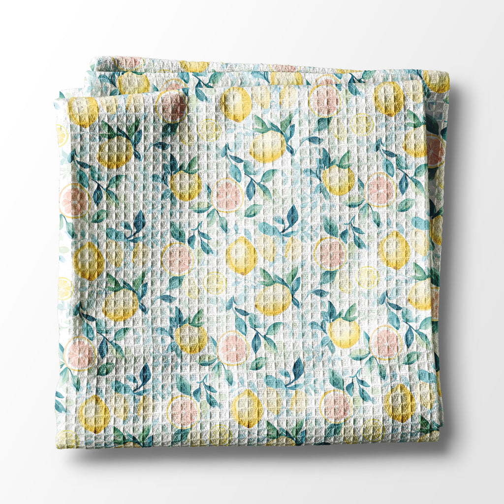 Floral and lemon patterned kitchen towel with lemon design on a white background
