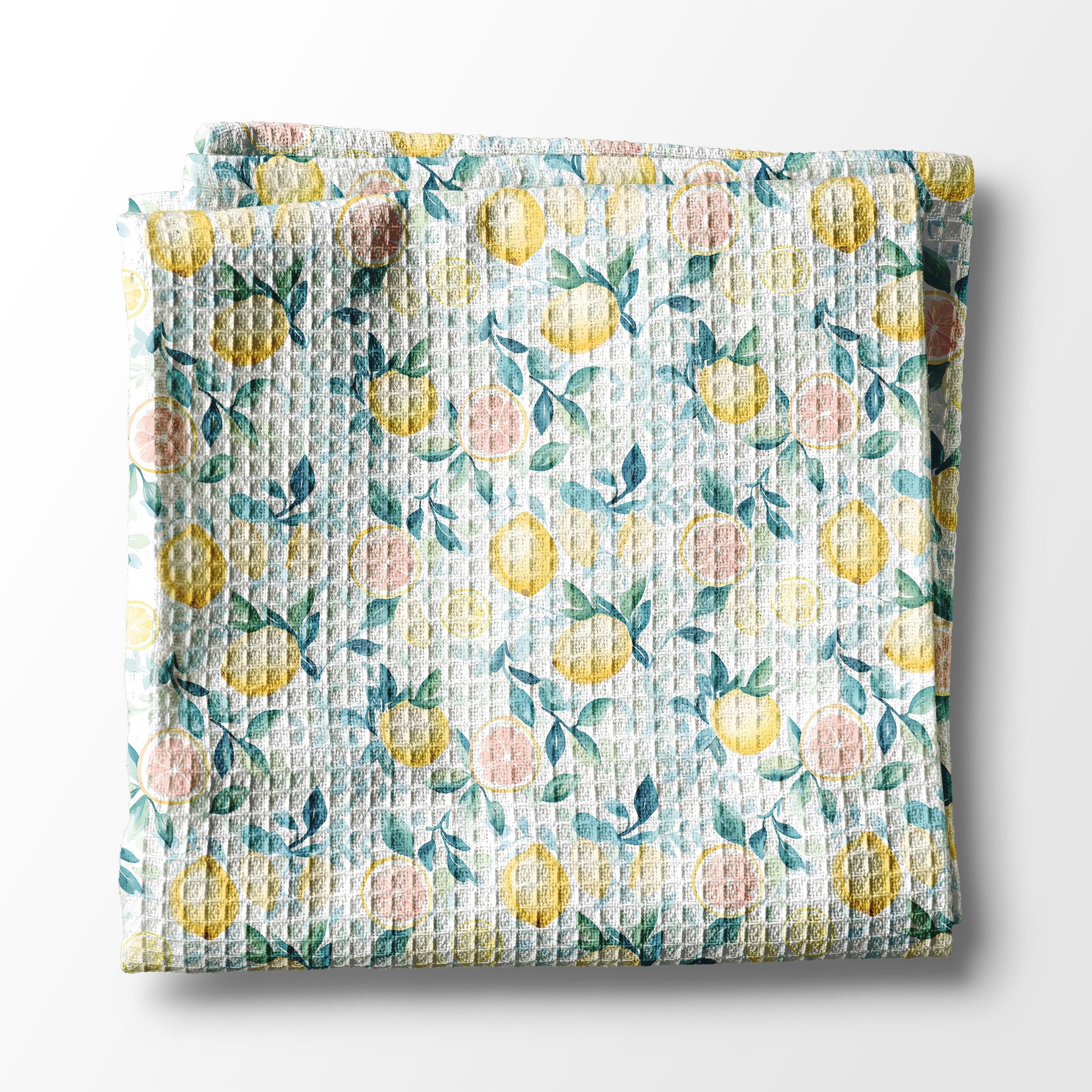 Floral and lemon patterned kitchen towel with lemon design on a white background