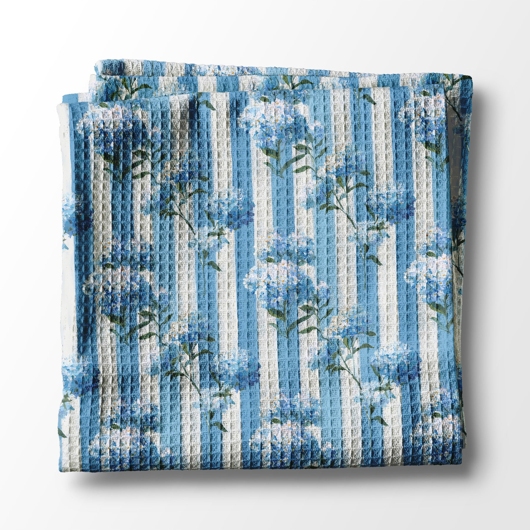 Floral patterned kitchen towel with blue and white flowers on a white background