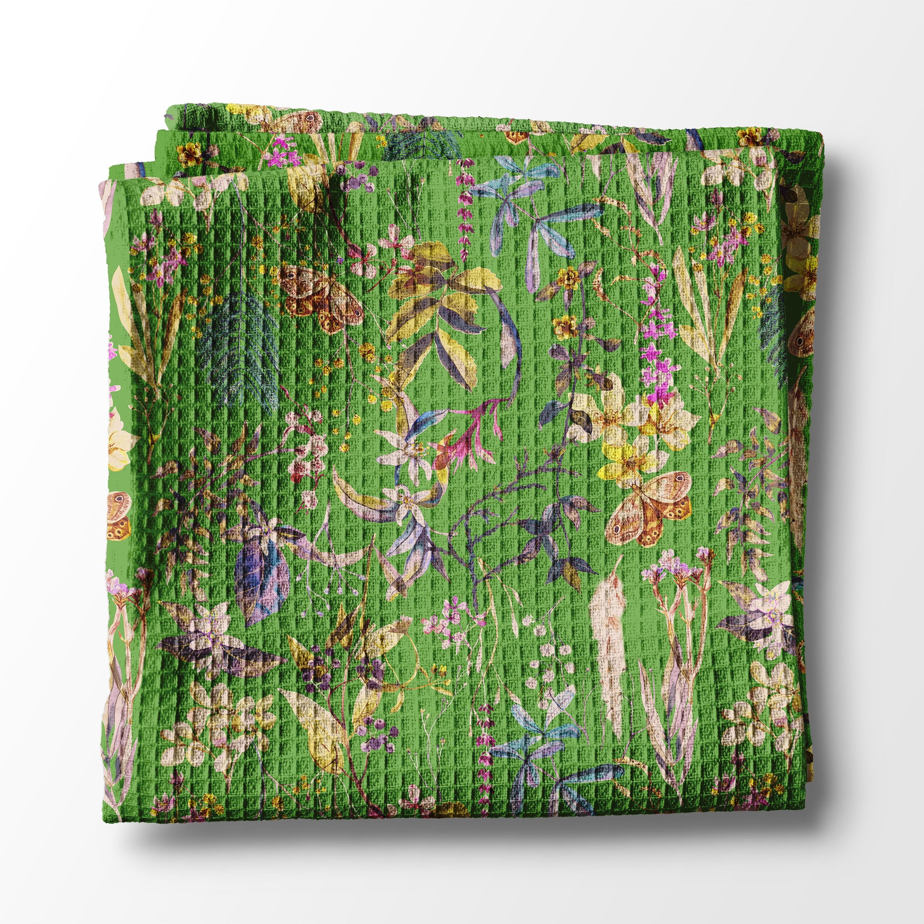 Folded green kitchen towel with floral pattern on a white background