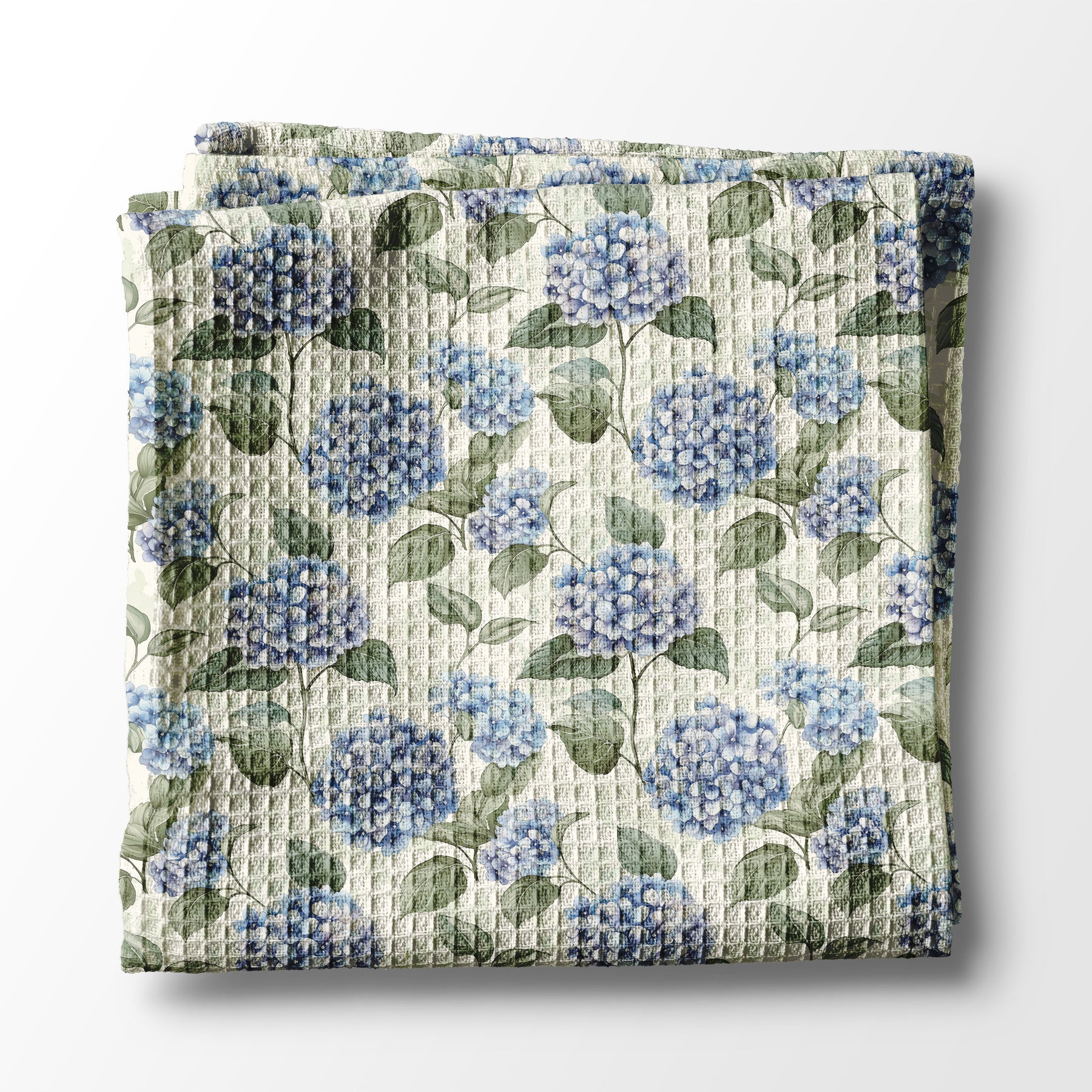 Floral kitchen towel with blue flowers and green leaves on a white background