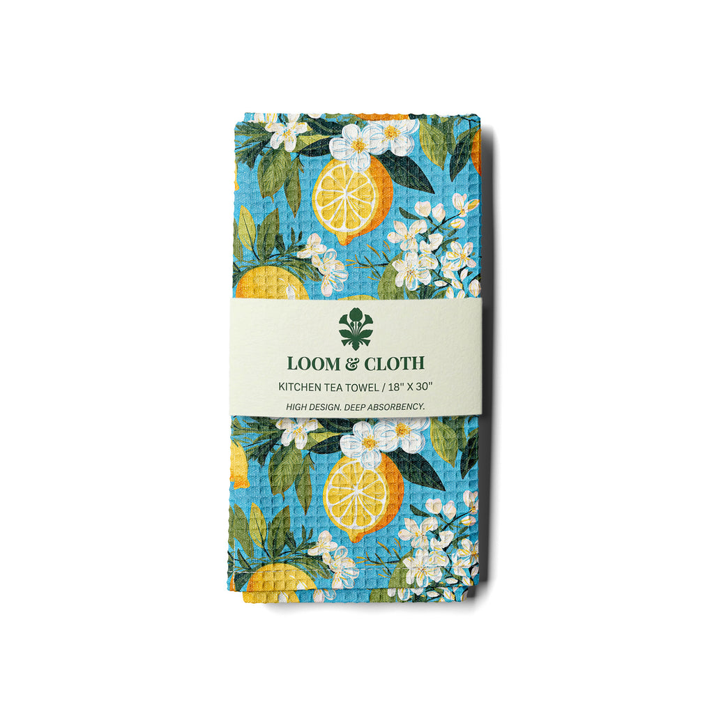 kitchen tea towel with lemon and floral design on a white background