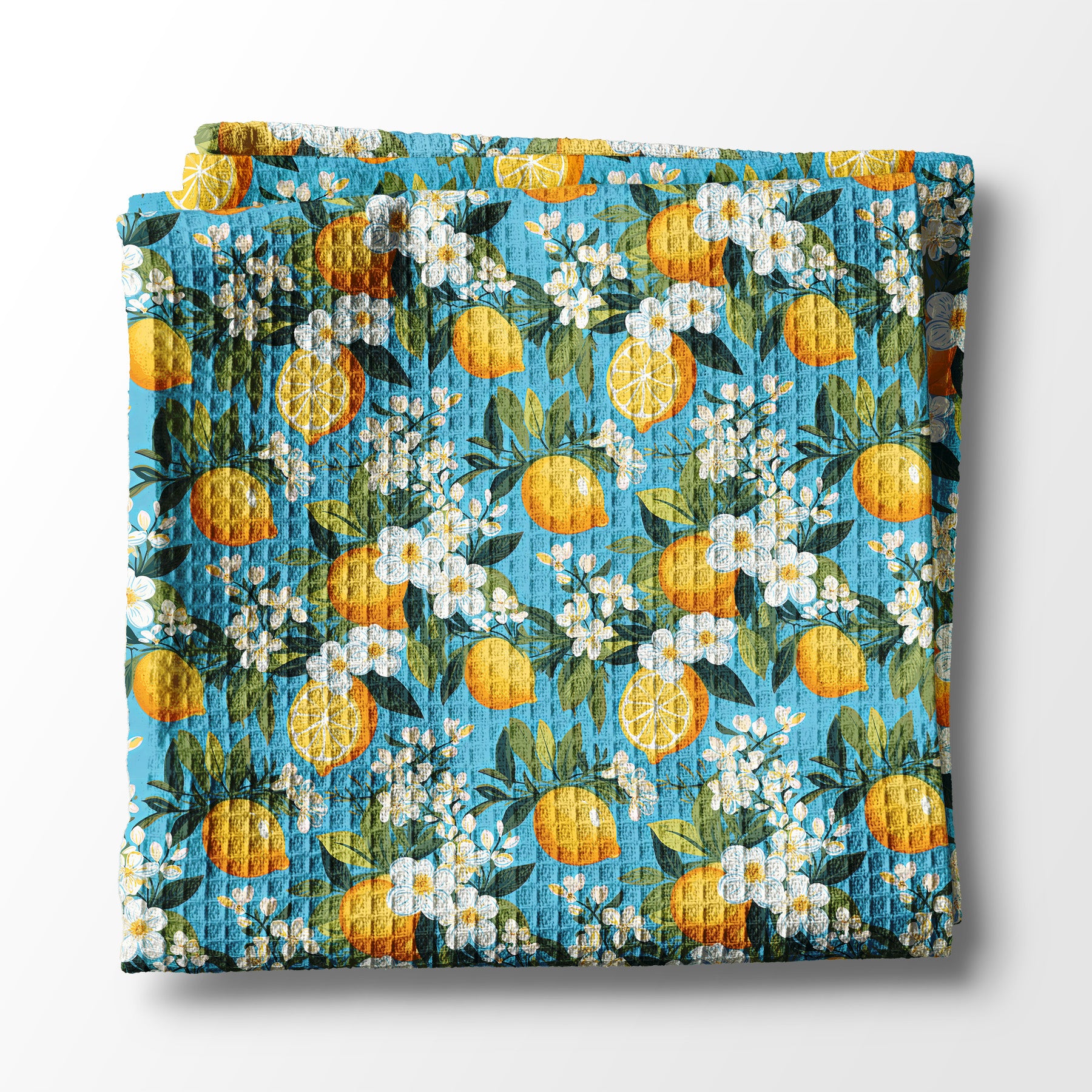 Floral and lemon-patterned kitchen towel on a white background