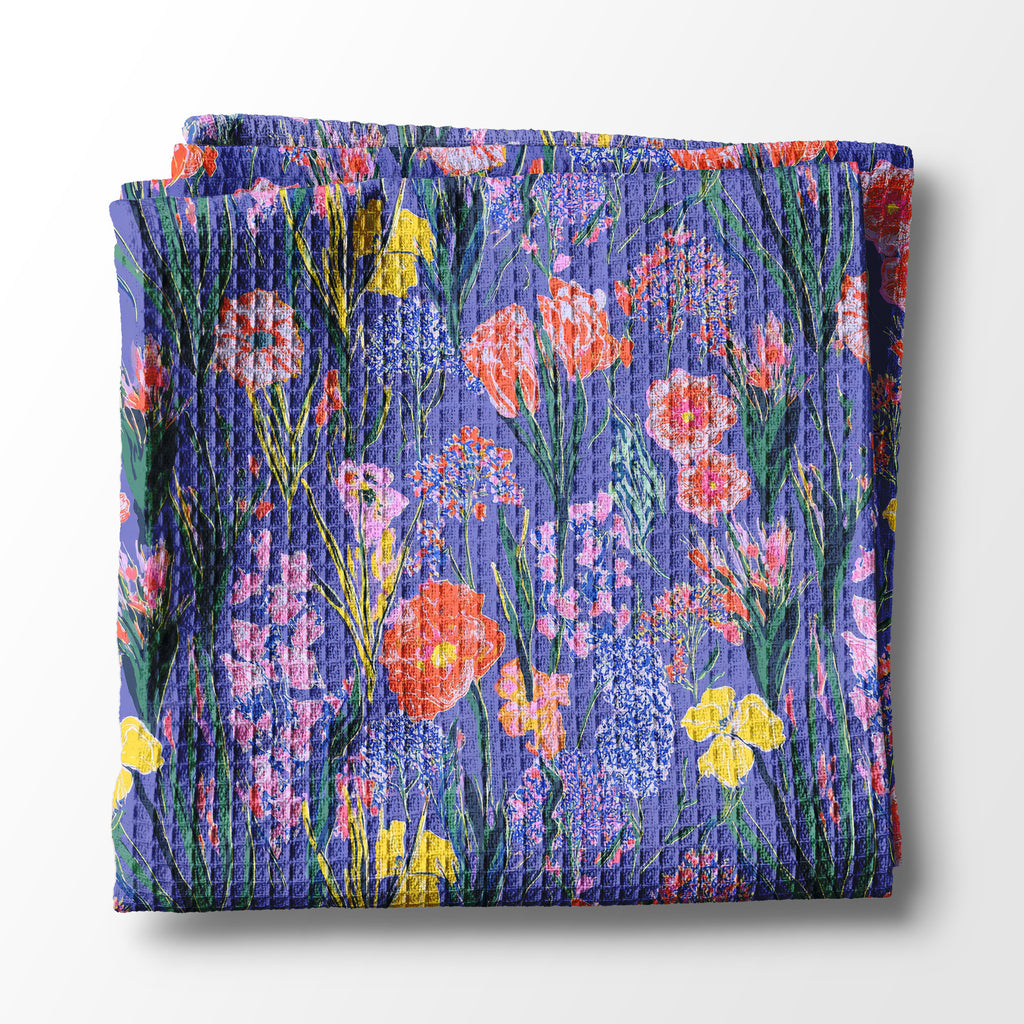 Folded kitchen towel with a floral pattern on a white background