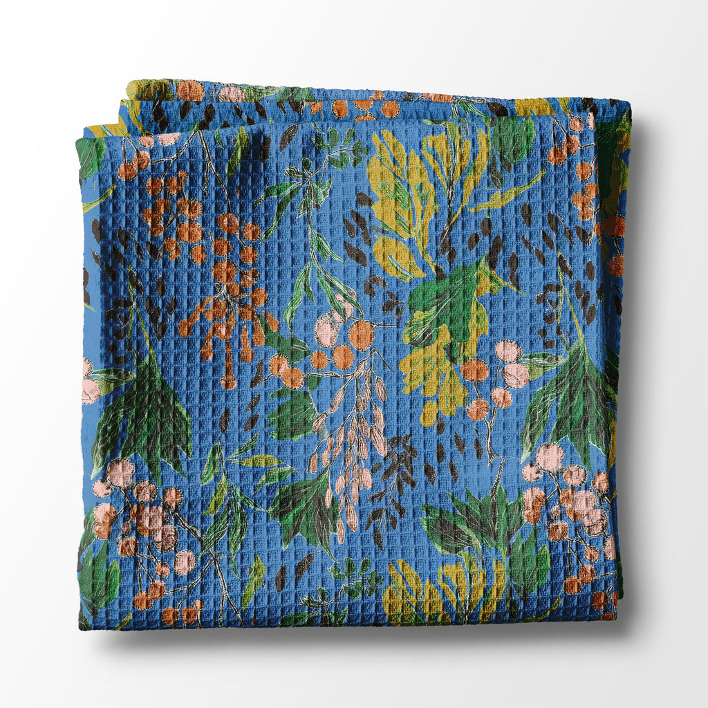 Folded kitchen towel with floral pattern on a white background