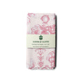 Packaged kitchen tea towel with floral pattern and Loom & Cloth branding on a white background