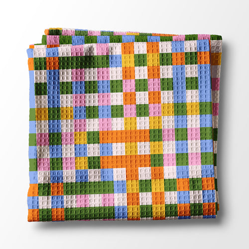 Colorful kitchen towel with a geometric pattern on a white background