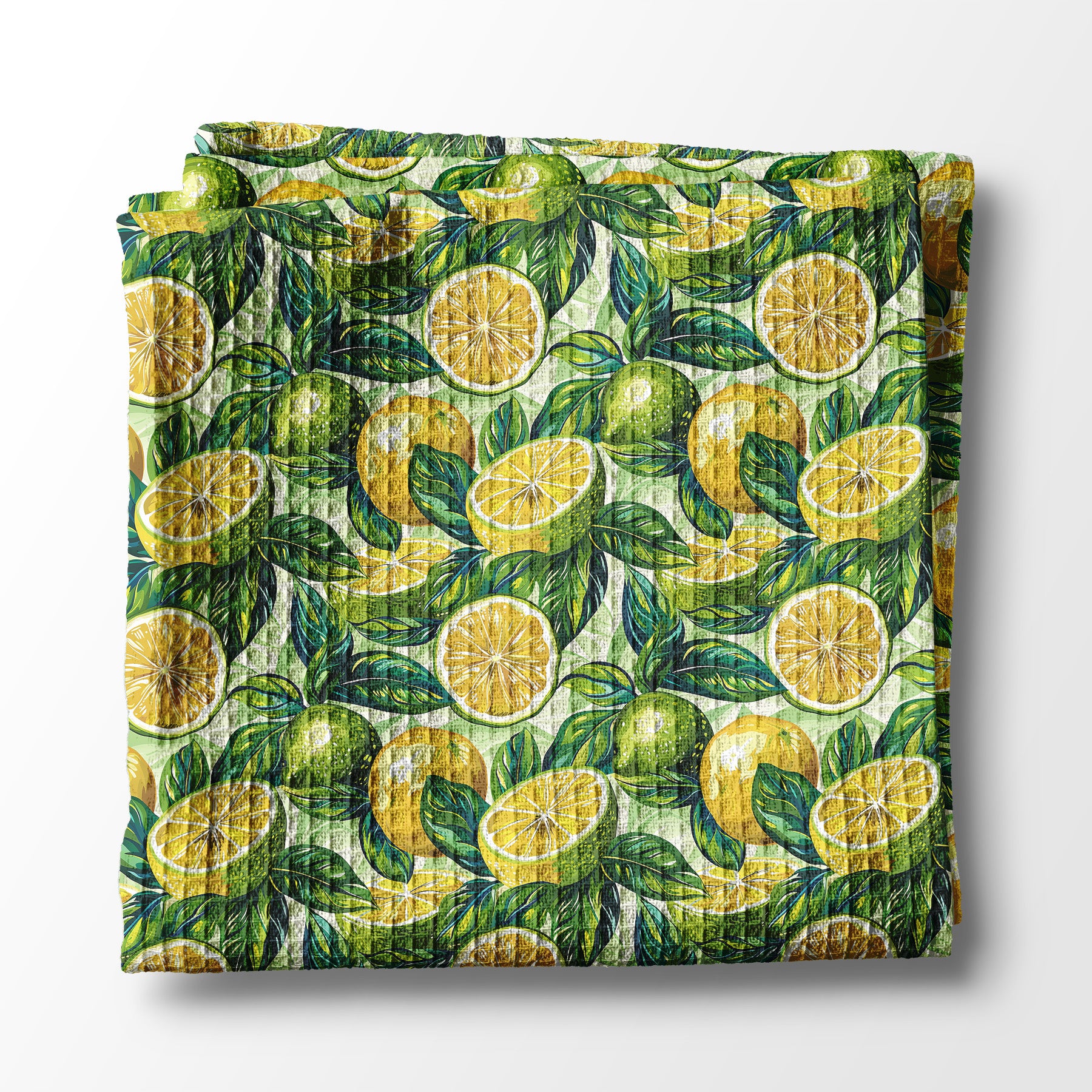 Folded kitchen towel with lemon and leaf pattern on a white background