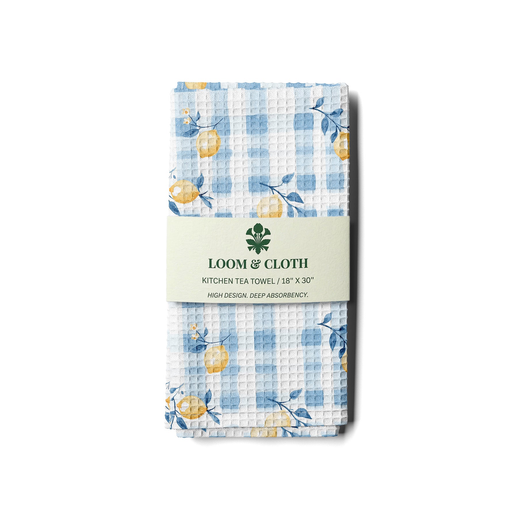 Packaged kitchen tea towel with blue checkered pattern and lemon design, featuring Loom & Cloth branding.