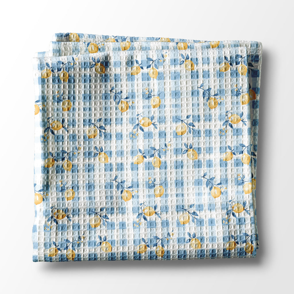 Floral patterned kitchen towel  with blue and yellow flowers on a white background
