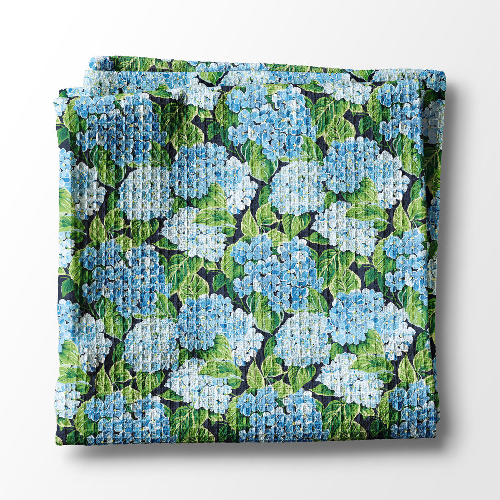 Folded kitchen towel with floral pattern on a white background