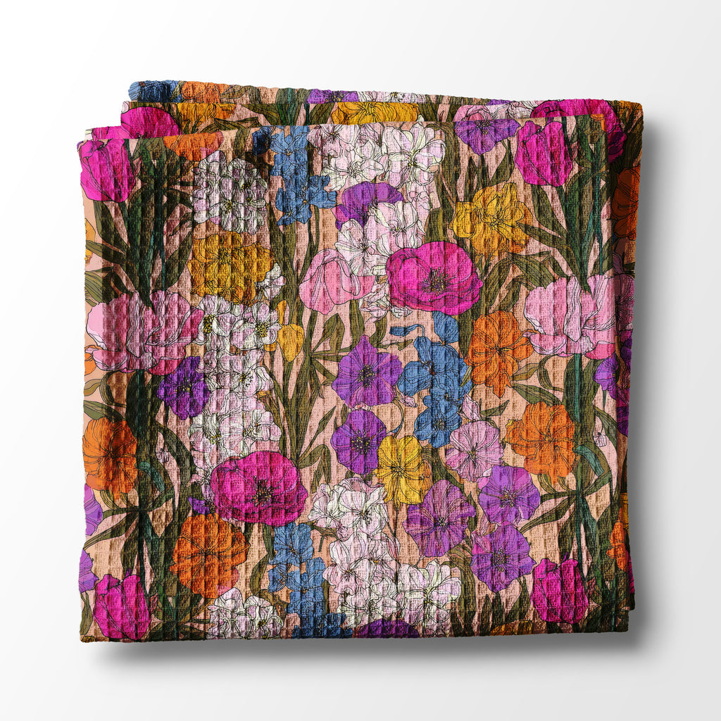 Folded kitchen towel with colorful floral pattern on a white background