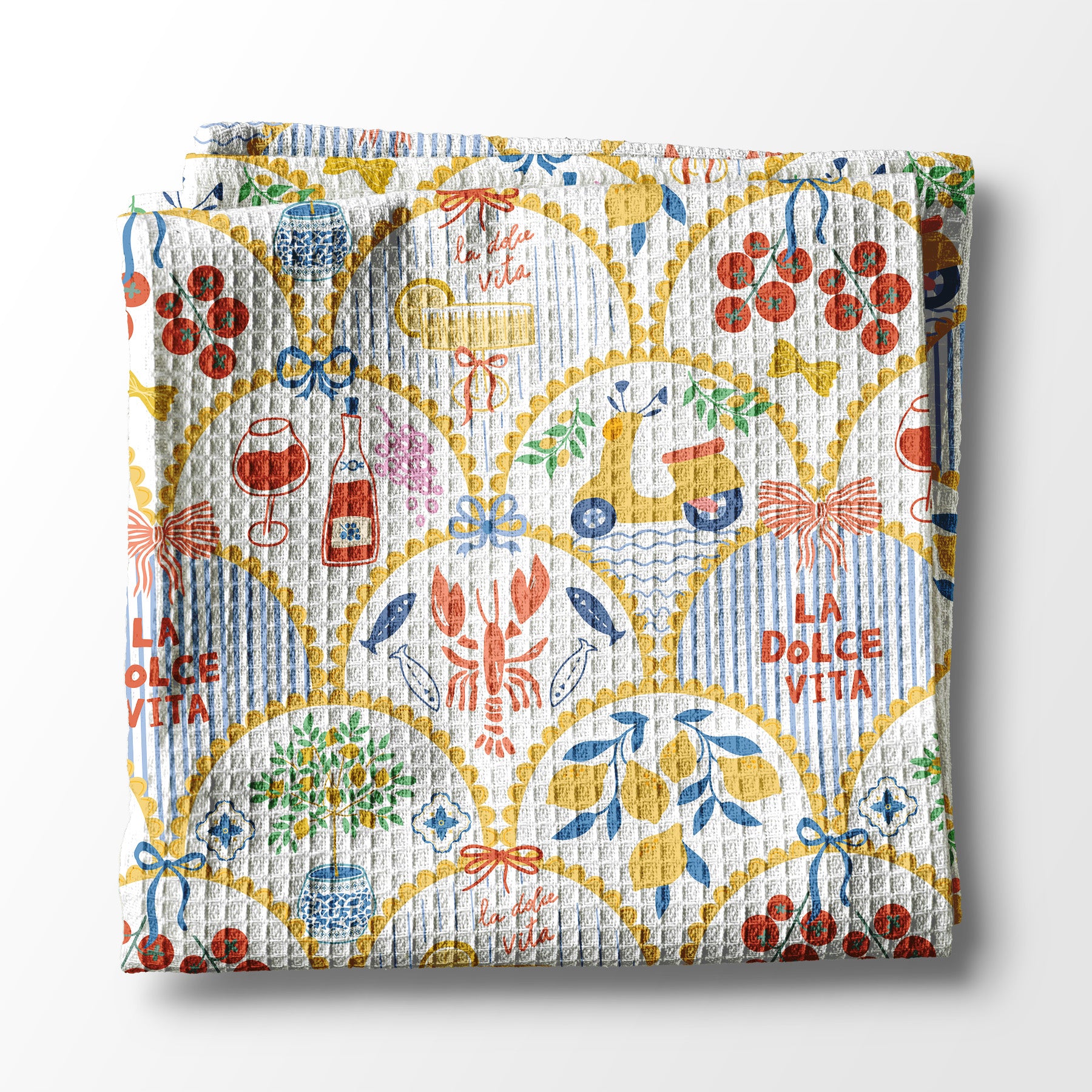 Colorful kitchen towel with 'La Dolce Vita' design on a white background