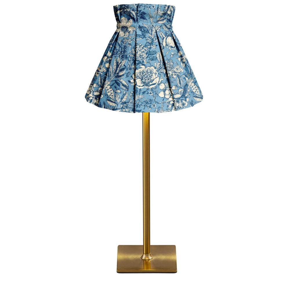 Helene pattern lampshade cover on a lamp with a gold stand against a white background