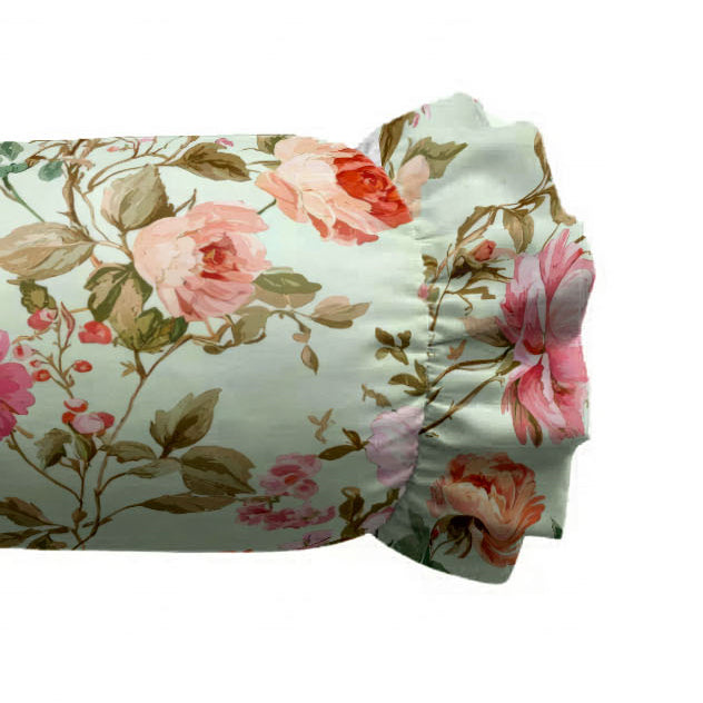 Floral-patterned fabric with pink roses and green leaves on a white background