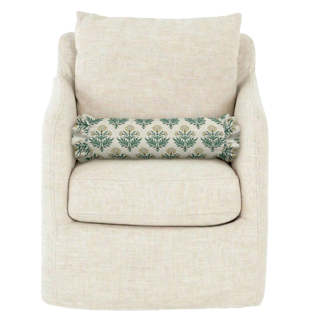 Beige armchair with a floral-patterned pillow on a white background