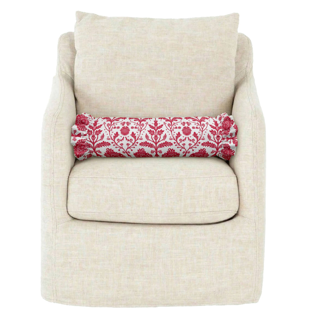 Beige armchair with a red and white patterned cylindrical pillow on a white background
