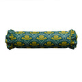 Rolled-up fabric with green and yellow pattern on a white background