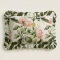 Floral and leaf patterned pillow on a light background