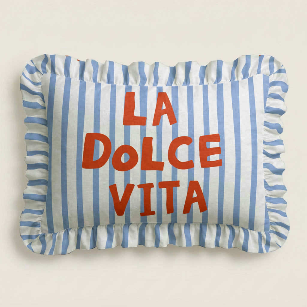 Striped pillow with 'La Dolce Vita' text on a plain background