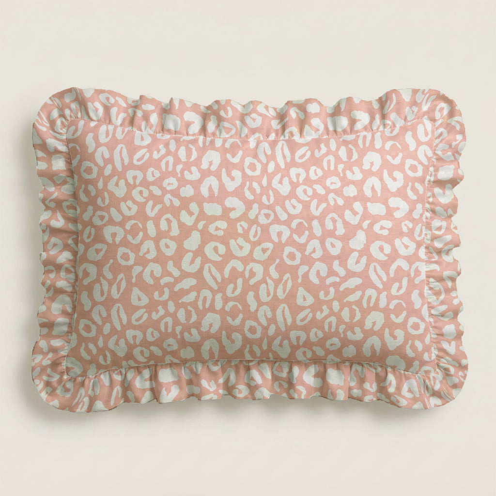 Pink pillow with white leopard print pattern on a beige background