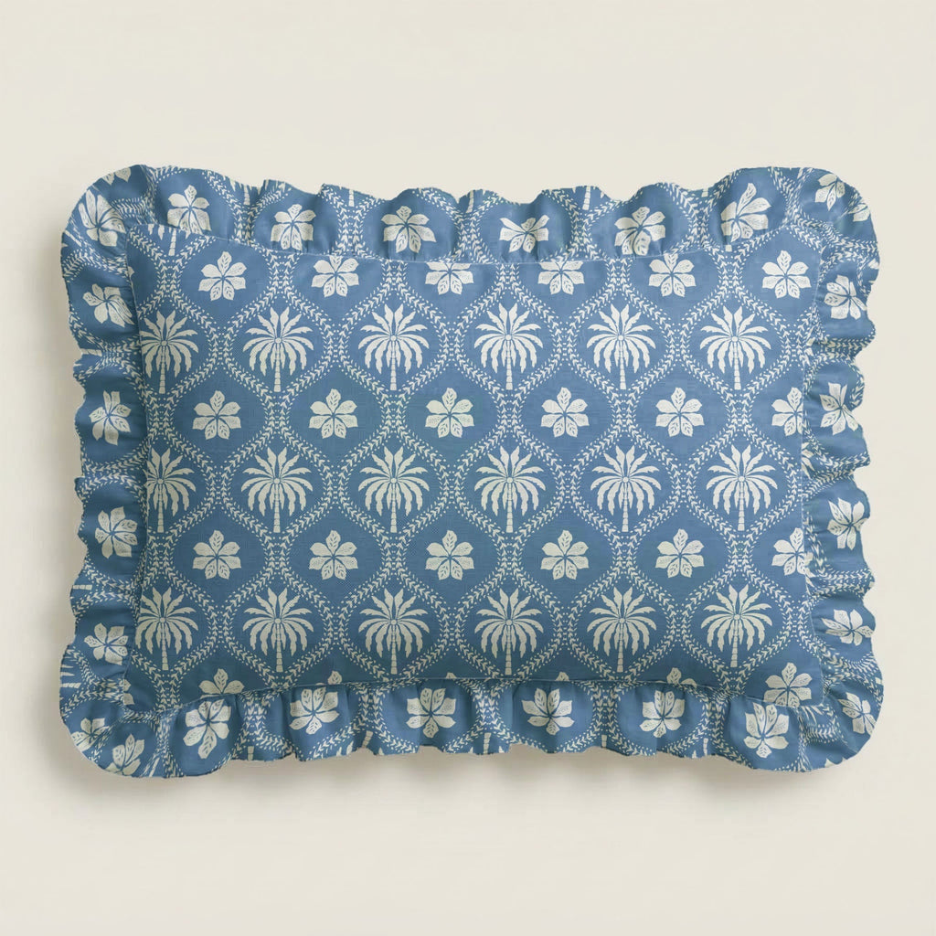Blue fabric placemat with white floral pattern on a light gray background