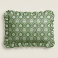 Green fabric with white floral pattern on a beige background