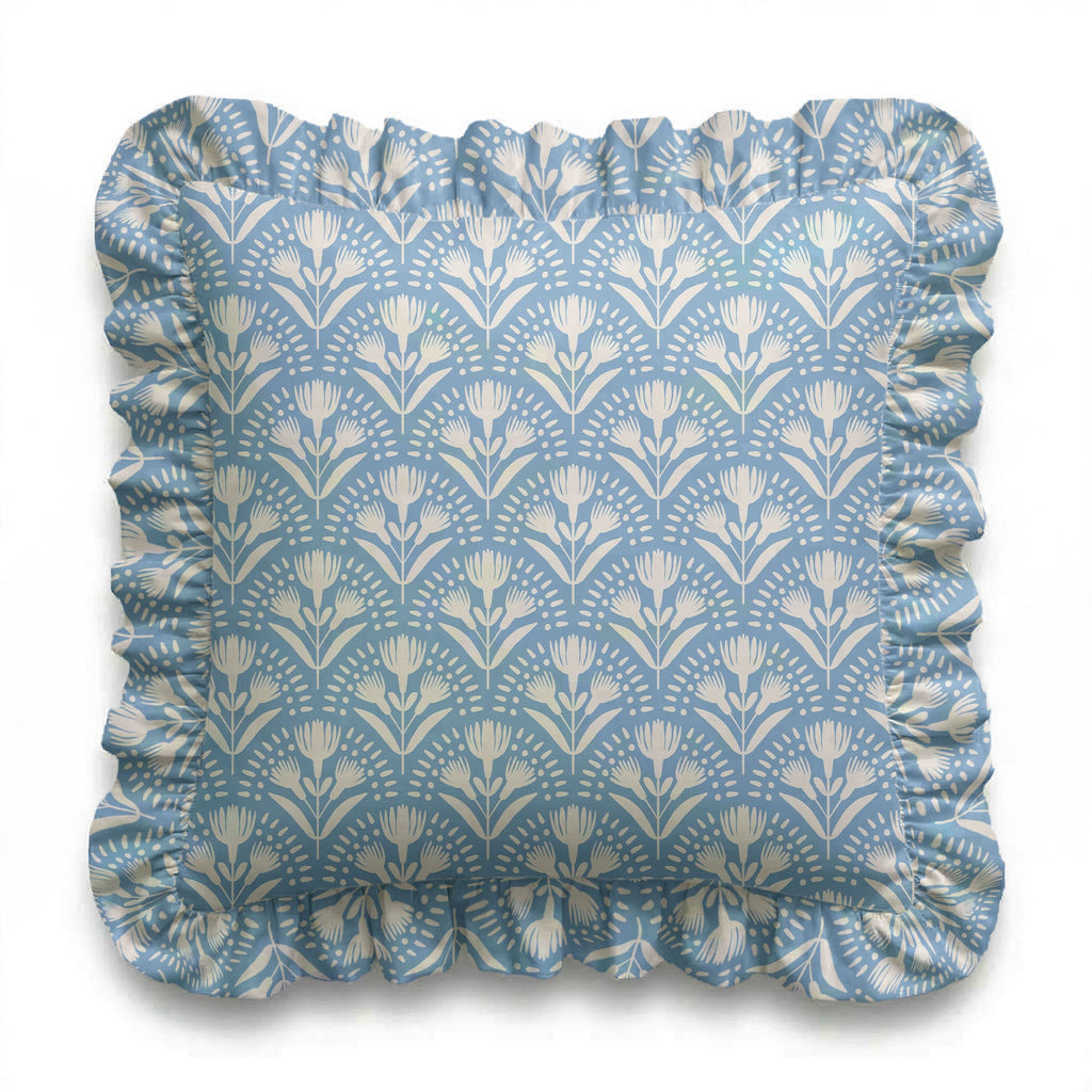 Decorative pillow with floral pattern and ruffled edge on a white background