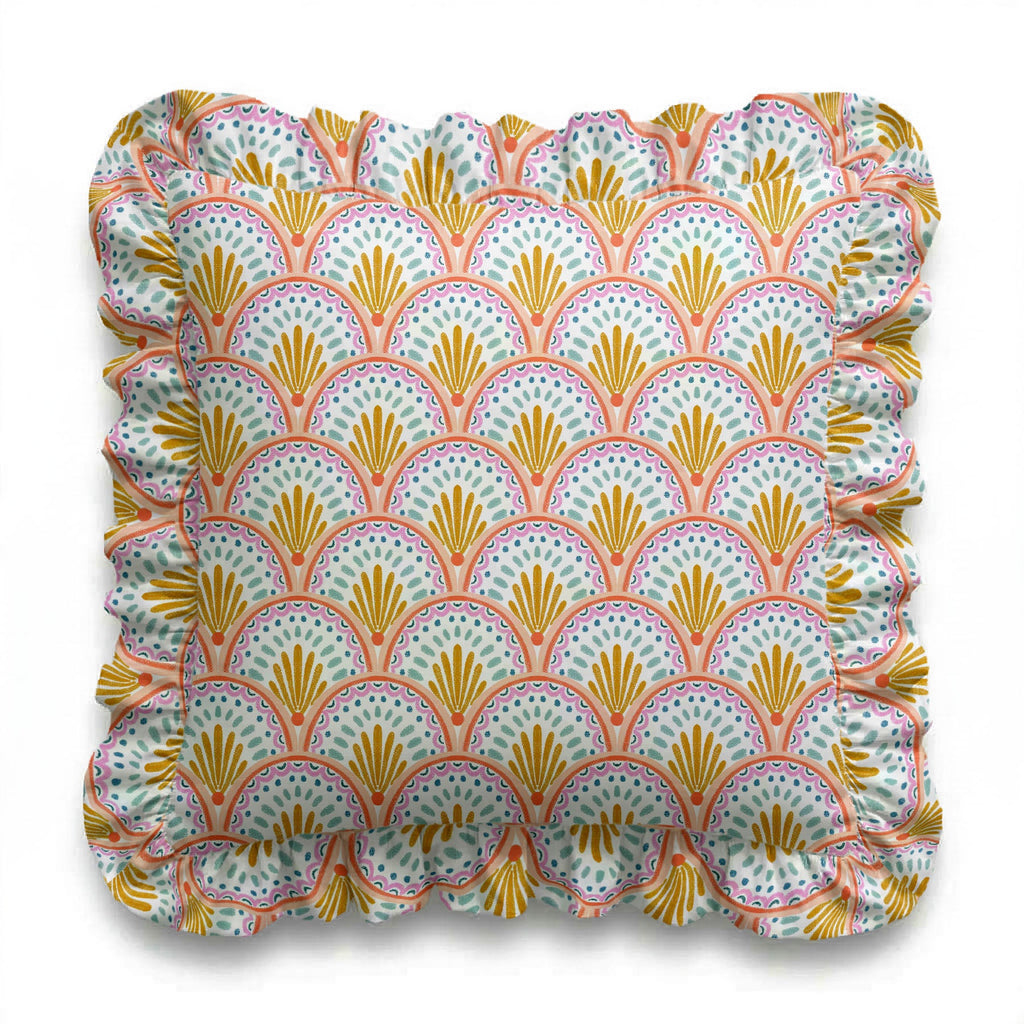 Decorative pillow with a colorful shell pattern on a white background