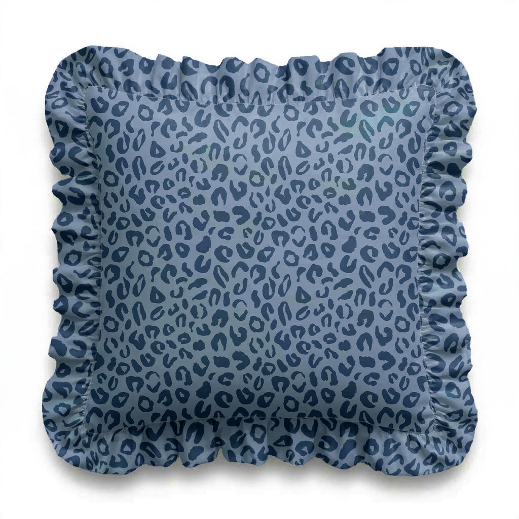 Blue patterned cushion with ruffled edge on a white background