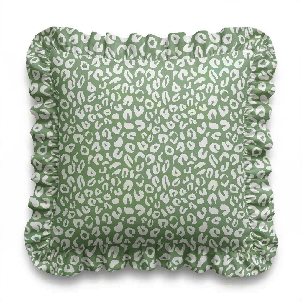 Green cushion cover with white leopard print pattern on a white background