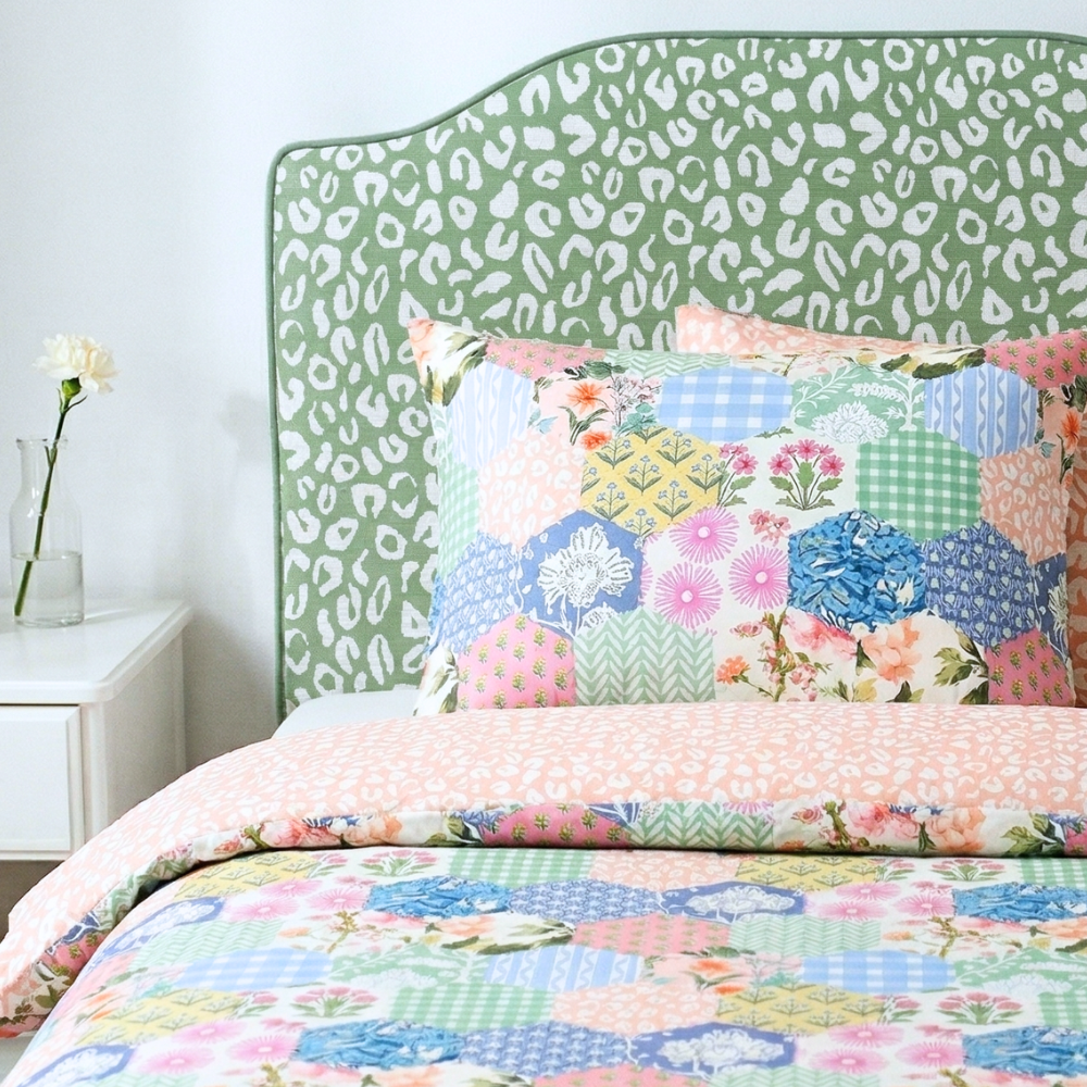 Bed with floral bedding and green leopard print headboard