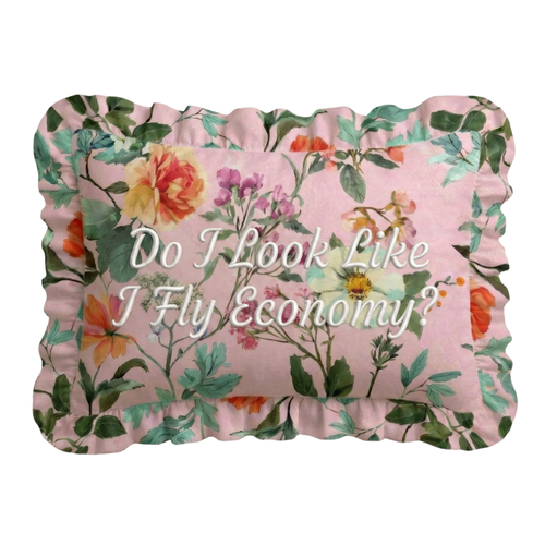 Floral pillow with text 'Do I Look Like I Fly Economy?' on a white background