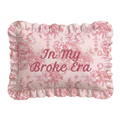 Decorative pillow with floral pattern and text 'In My Broke Era' on a white background