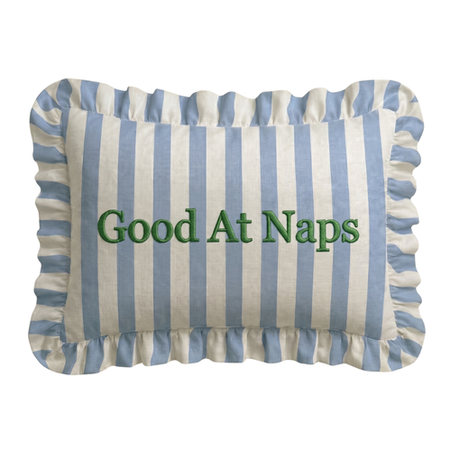 Striped pillow with 'Good At Naps' text on a white background