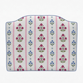 Floral patterned cushion with pink stripes on a white background